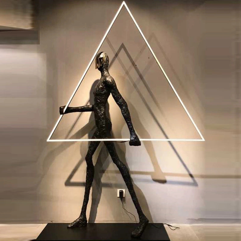 Human Holding Triangle Sculpture